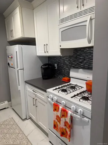 a kitchen with stainless steel appliances granite countertop a stove and a refrigerator