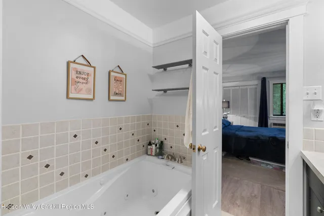 a bathroom with a bathtub and a shower