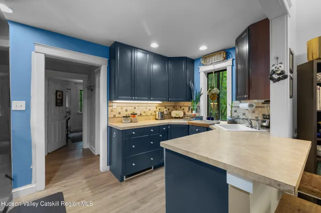 a kitchen with stainless steel appliances a sink stove and refrigerator