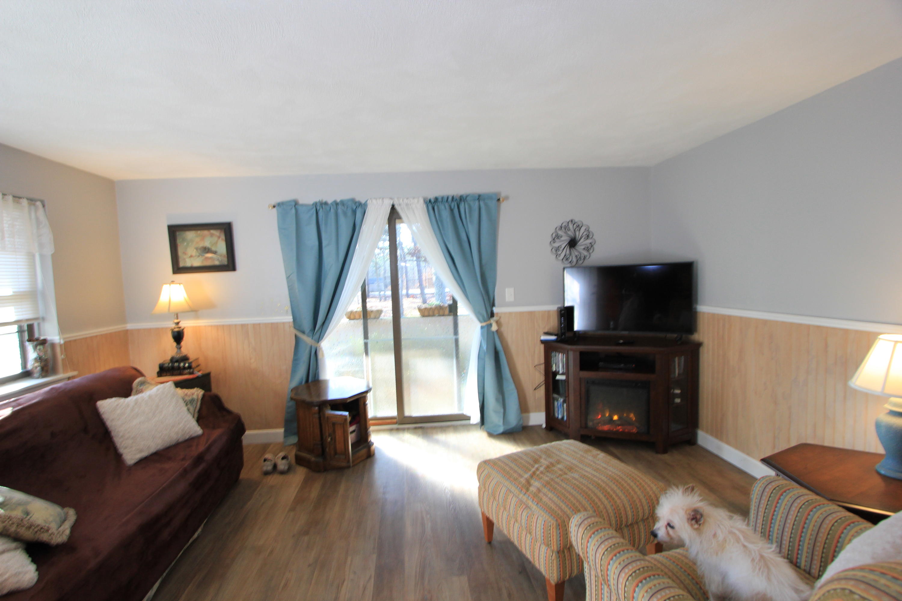35 Ashumet Road, Unit 10B Mashpee, MA 02649 - Photo 3 of 13 a living room with furniture and a flat screen tv