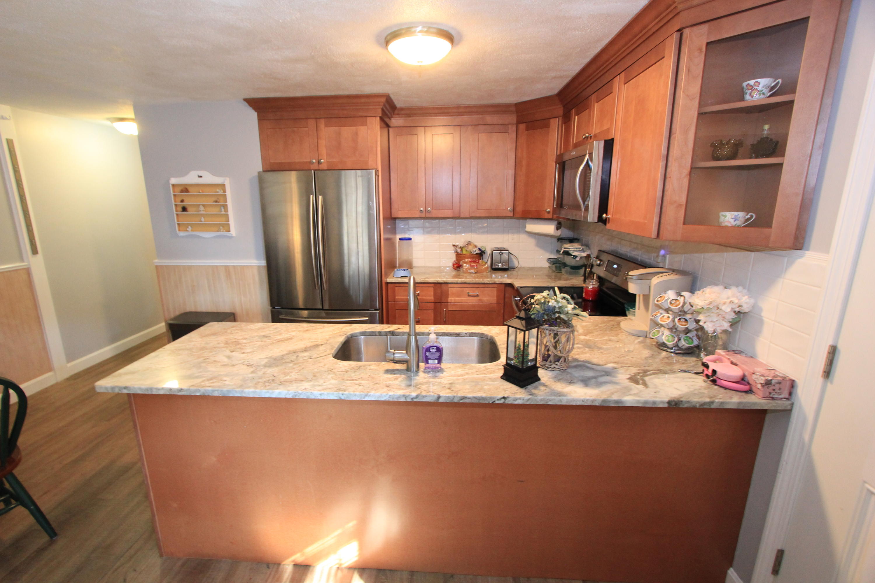 35 Ashumet Road, Unit 10B Mashpee, MA 02649 - Photo 6 of 13 a bathroom with a granite countertop sink a mirror and shower
