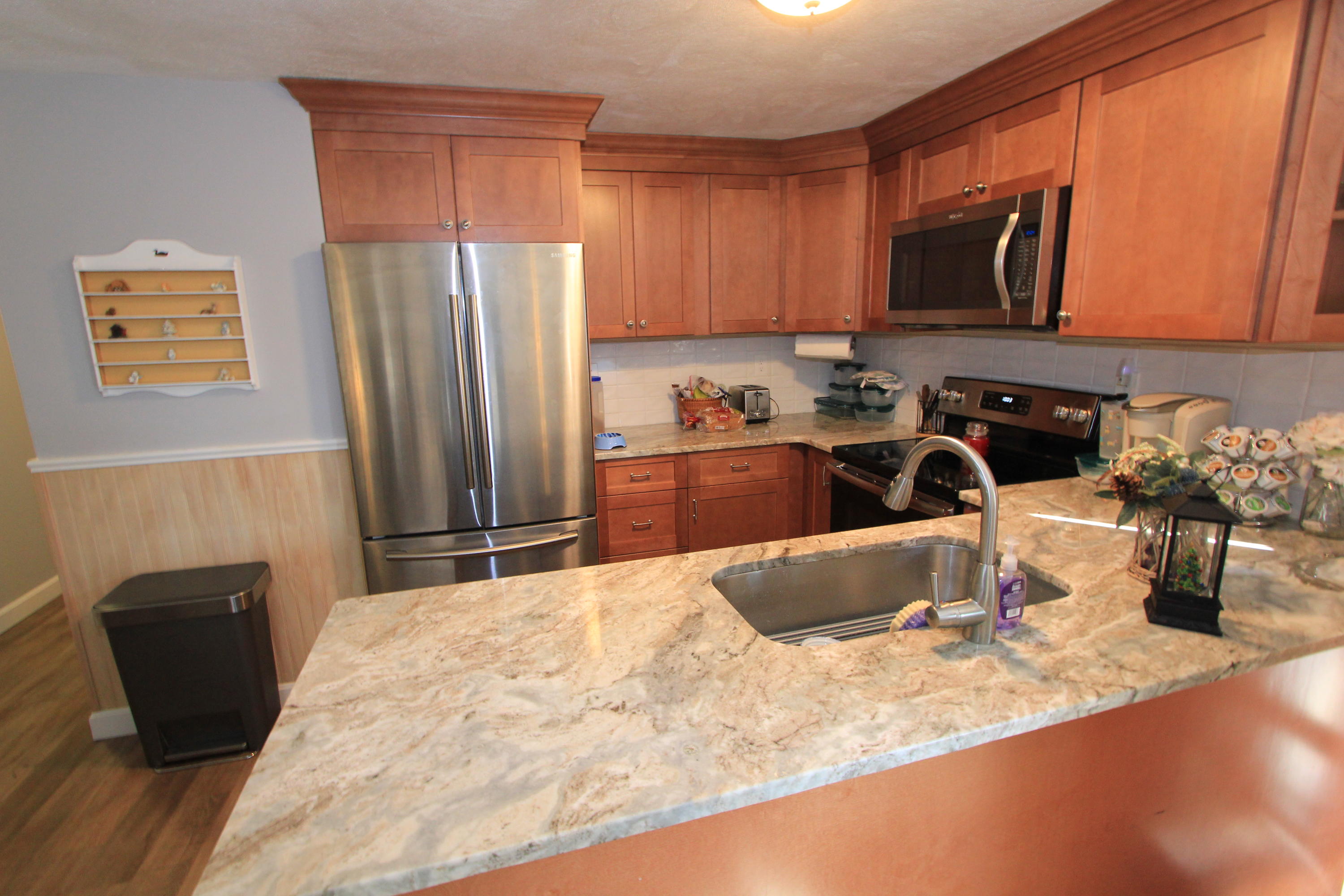 35 Ashumet Road, Unit 10B Mashpee, MA 02649 - Photo 8 of 13 a kitchen with stainless steel appliances granite countertop a sink refrigerator and microwave