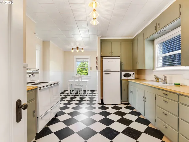 a kitchen with a refrigerator a sink and a cabinets