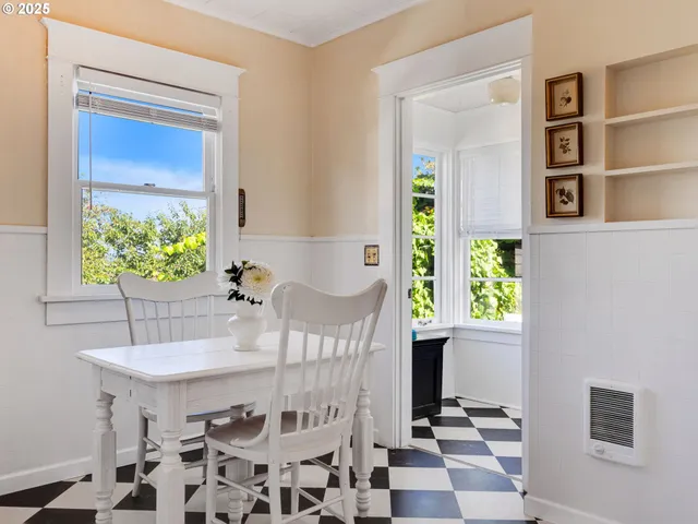 a view of a dining room with a table and chairs