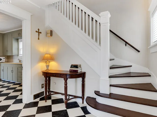 a view of entryway with wooden floor and windows