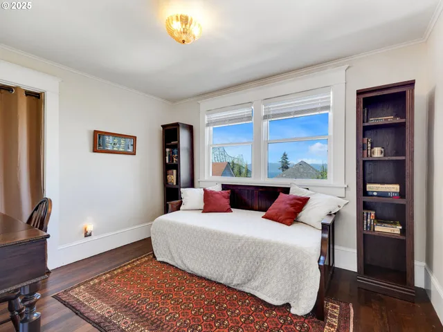 a bedroom with a large bed and a window