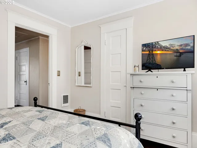 a view of room with wooden floor and flat screen tv