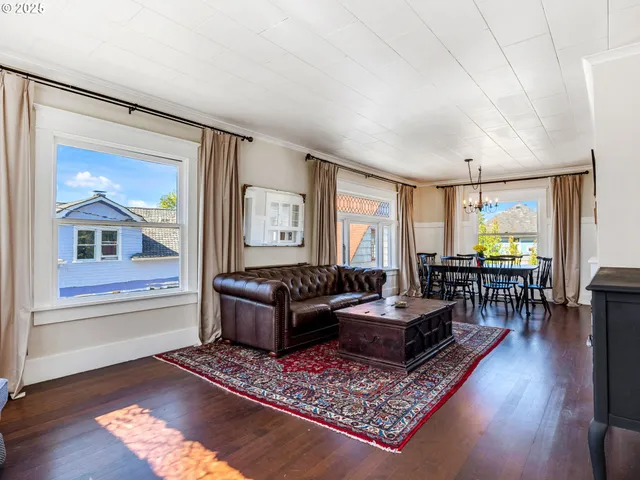 a living room with furniture rug and window