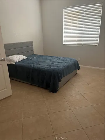 a bedroom with a bed and window