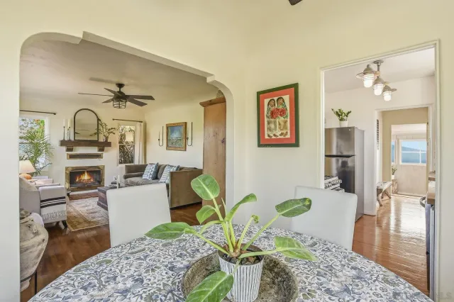 a dining room with furniture a chandelier and wooden floor
