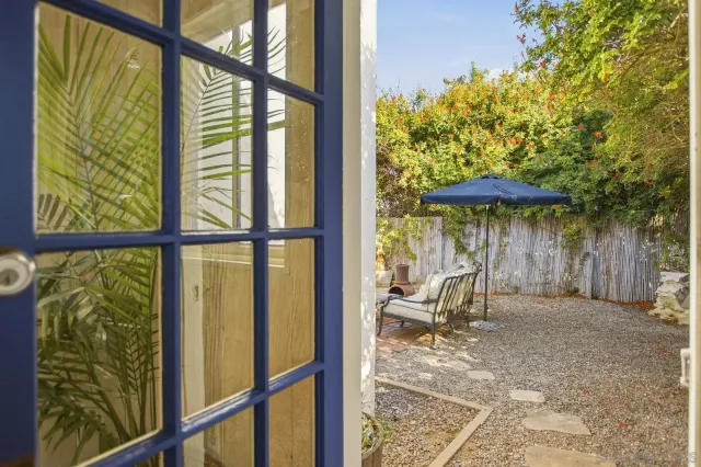 a backyard of a house with table and chairs
