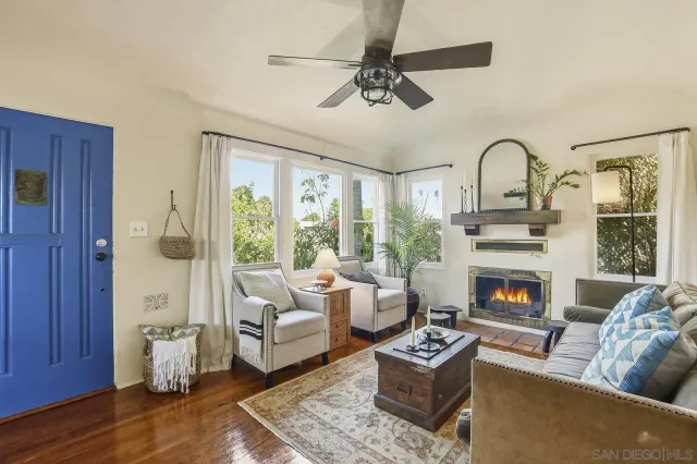 a living room with furniture and a large window with garden view