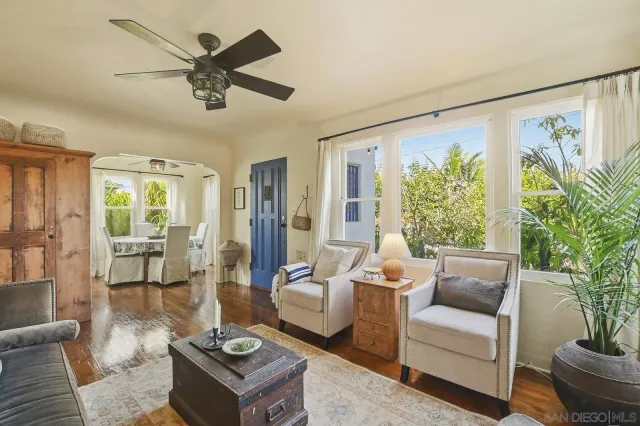 a living room with furniture a fireplace and a large window