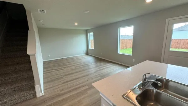 a kitchen with stainless steel appliances a refrigerator and a stove top oven