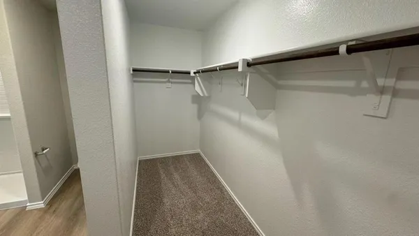 a view of a house with a yard and wooden fence