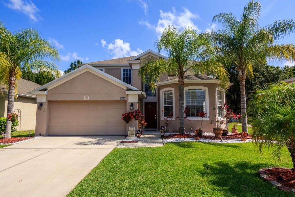 10025 Oak Crest Road Orlando, FL 32829 - Photo 1 of 1 a front view of a house with a yard and garage