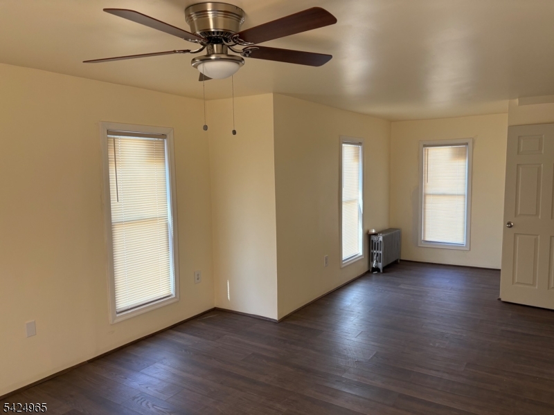 7 Filmore Street, Unit 2 Phillipsburg, NJ 08865 - Photo 8 of 14 an empty room with wooden floor chandelier fan and windows