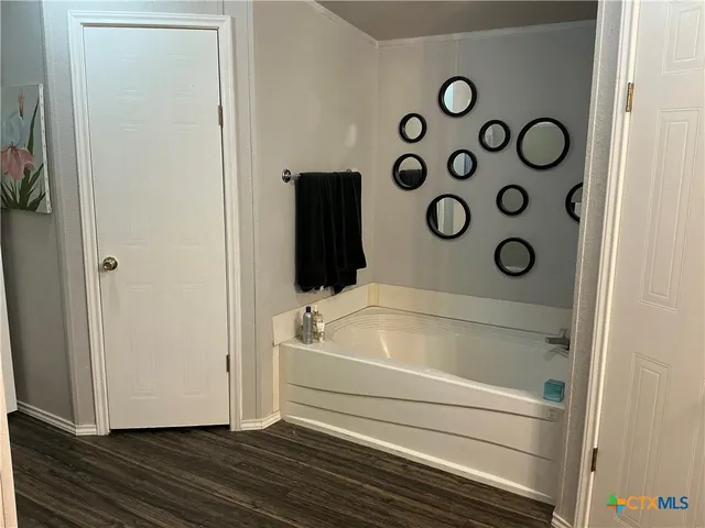 a bathroom with a bathtub and window