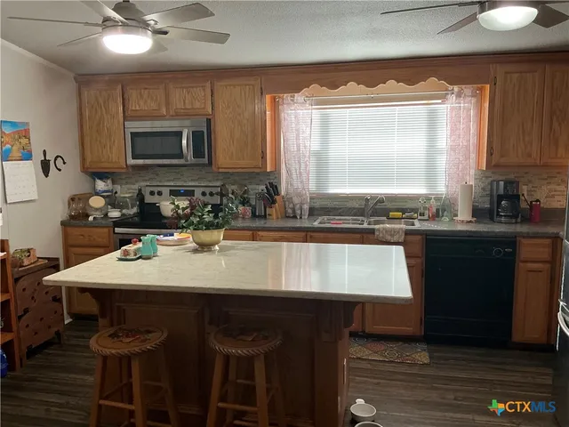 a kitchen with a sink cabinets and window
