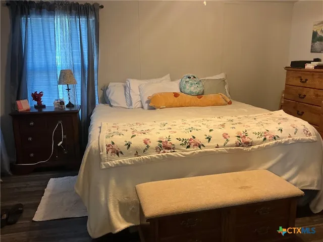 a bedroom with a bed and dresser