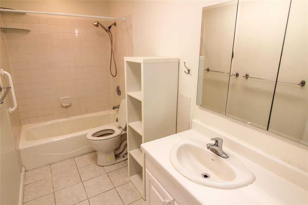 11705 Cherokee Street, Unit B Austin, TX 78753 - Photo 10 of 18 a bathroom with a sink toilet and shower