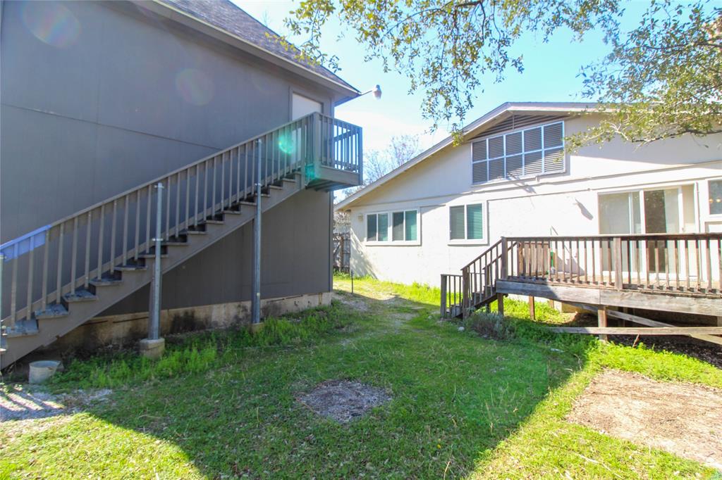 11705 Cherokee Street, Unit B Austin, TX 78753 - Photo 13 of 18 a view of a house with a backyard and a deck