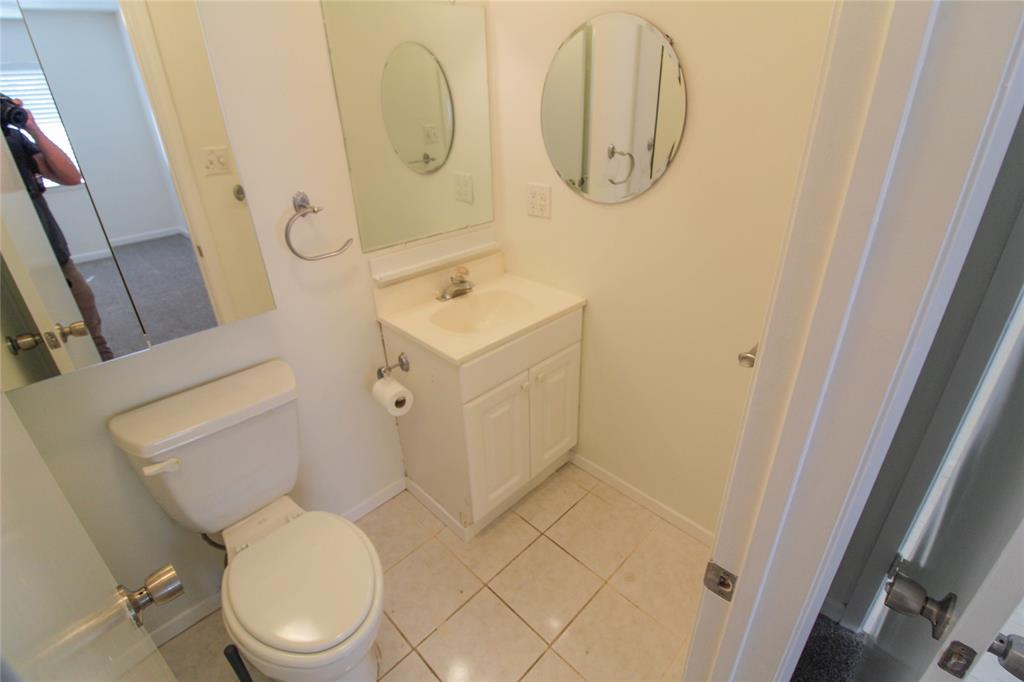 11705 Cherokee Street, Unit B Austin, TX 78753 - Photo 8 of 18 a white toilet sitting next to a bathroom sink