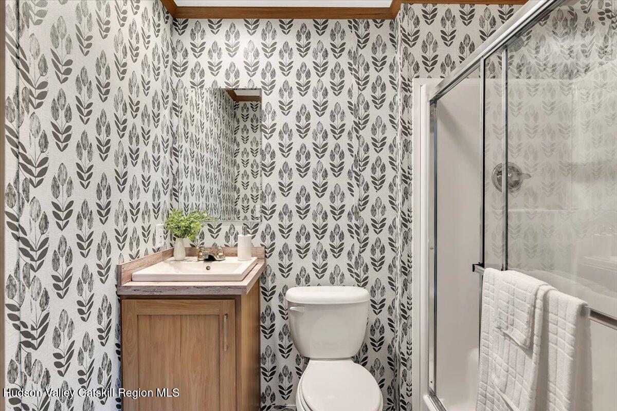 185 Old State Road, Unit 55 Broadalbin, NY 12025 - Photo 21 of 62 a bathroom with a toilet sink and mirror