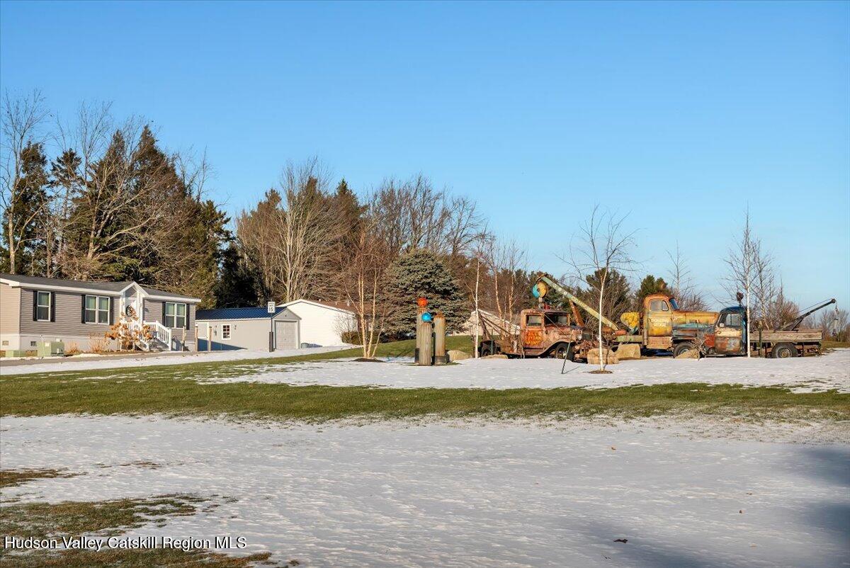 185 Old State Road, Unit 55 Broadalbin, NY 12025 - Photo 48 of 62 a view of a swimming pool with trees in the background