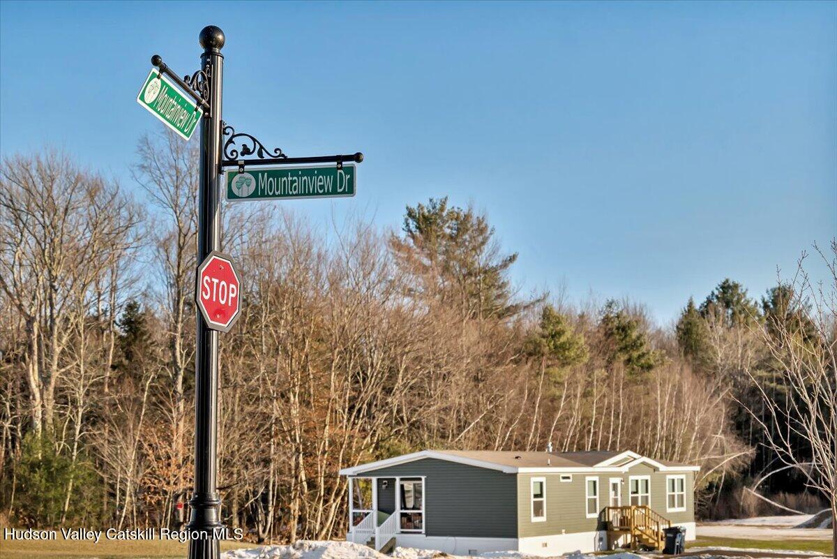 185 Old State Road, Unit 55 Broadalbin, NY 12025 - Photo 62 of 62 a street sign on a pole next to a road