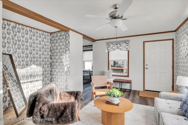 a living room with furniture and a chandelier