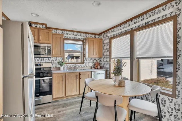a kitchen with a table and chairs in it