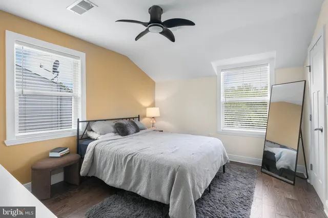 a bedroom with a bed dresser and a window