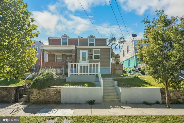 a front view of a house with a garden