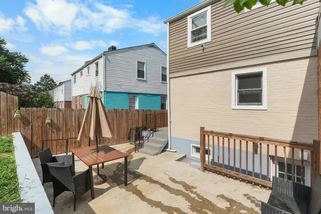 a view of a chairs and table in backyard of the house