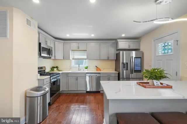 a kitchen with a sink appliances and cabinets
