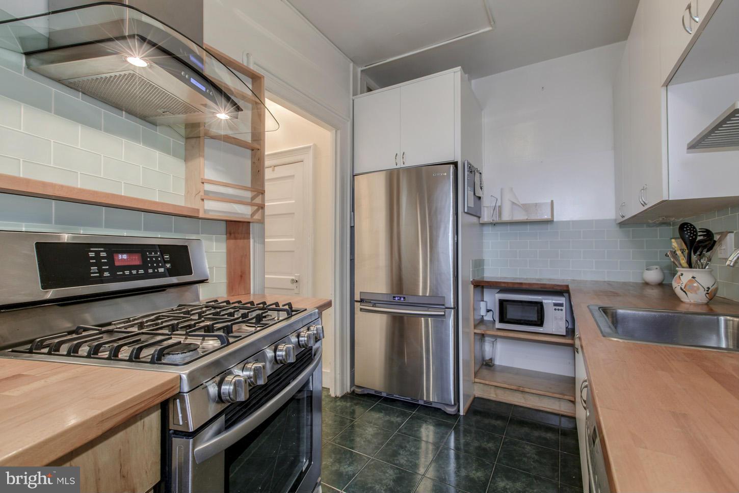 2022 Columbia Road Northwest, Unit 709 Washington, DC 20009 - Photo 11 of 21 Stainless Appliances & Glass Tile Backsplash