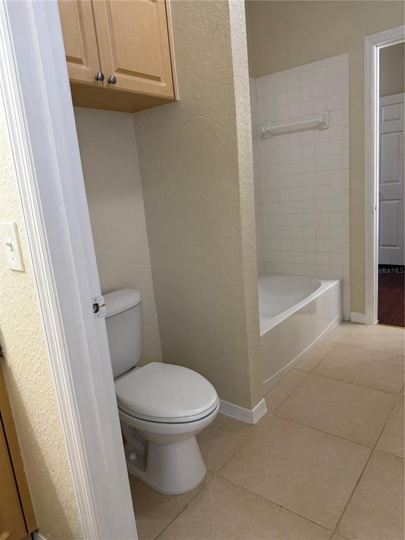 3725 Conroy Road, Unit 2127 Orlando, FL 32839 - Photo 23 of 30 a white toilet sitting next to a bath tub