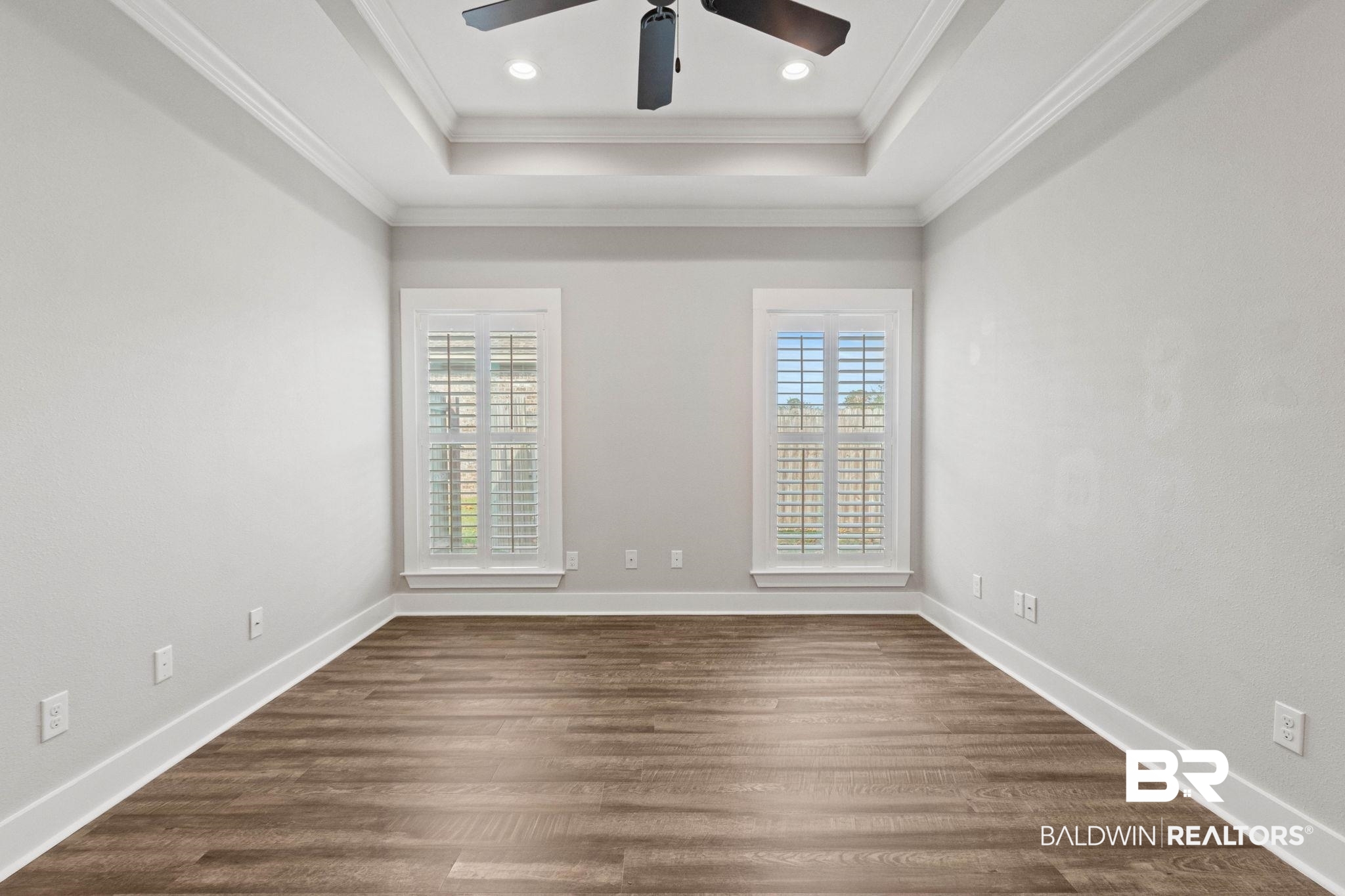 17376 Bankhead Boulevard Fairhope, AL 36532 - Photo 36 of 73 Spare room with dark wood finished floors, crown molding, a tray ceiling, and recessed lighting