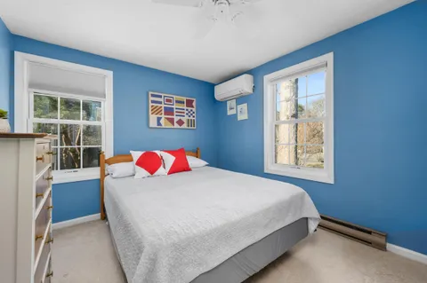 a room with a bed and a painting on the wall