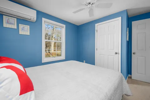 a bedroom with a large bed and a window