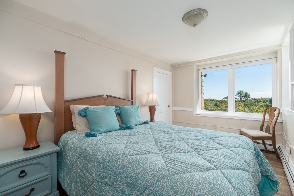15 Cliff Road Gloucester, MA 01930 - Photo 17 of 42 a bedroom with a bed and a lamp