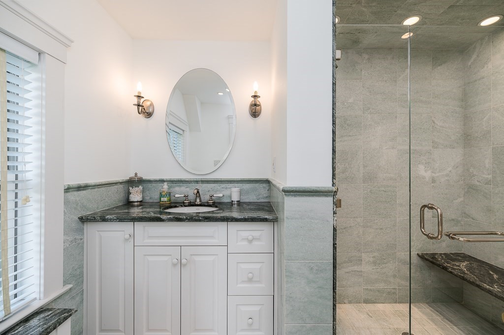 15 Cliff Road Gloucester, MA 01930 - Photo 25 of 42 a bathroom with a granite countertop sink a mirror and shower
