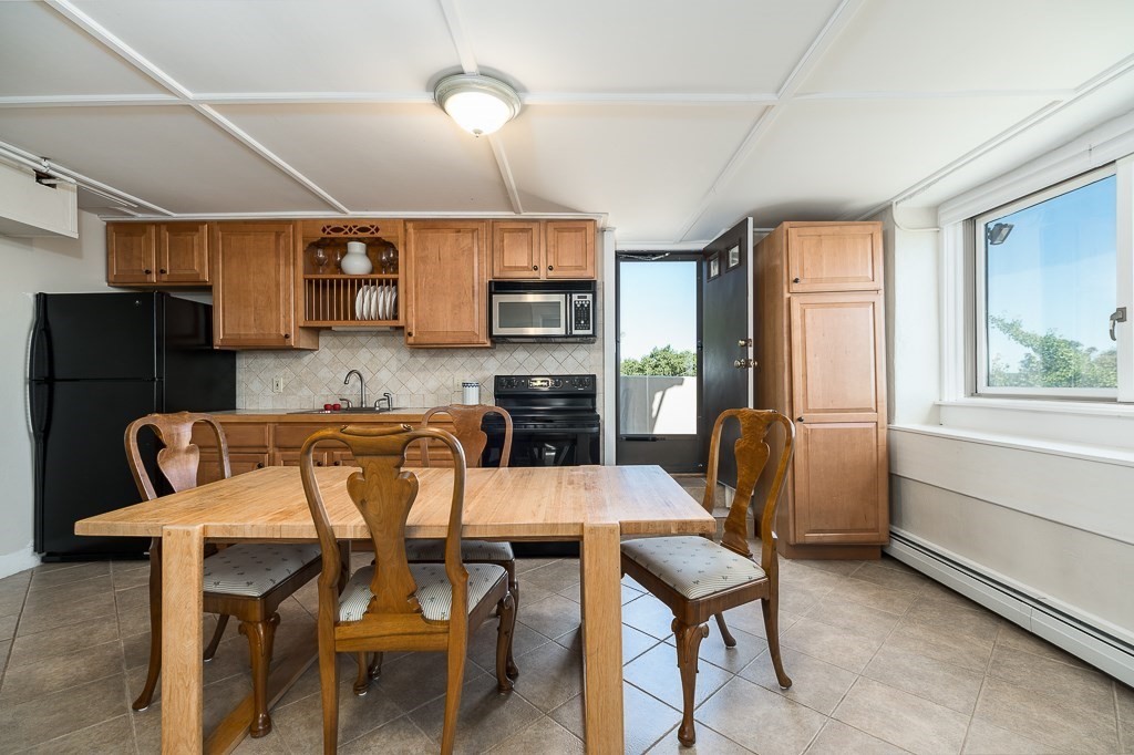 15 Cliff Road Gloucester, MA 01930 - Photo 31 of 42 a view of a dining room with furniture and a fireplace