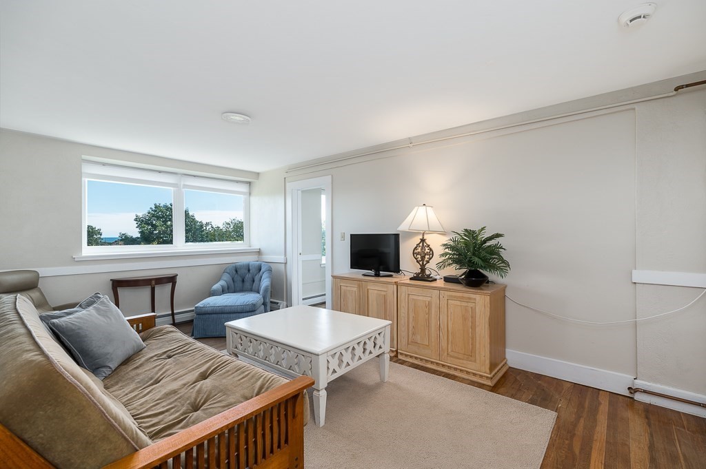 15 Cliff Road Gloucester, MA 01930 - Photo 32 of 42 a living room with furniture and a flat screen tv
