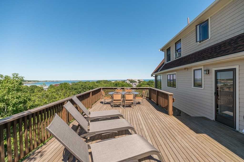 15 Cliff Road Gloucester, MA 01930 - Photo 5 of 42 a view of a roof deck with couches and sky view