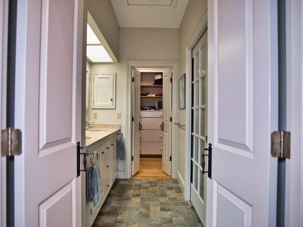 1958 Main Road Westport, MA 02791 - Photo 13 of 28 a view of a hallway with wooden shelves