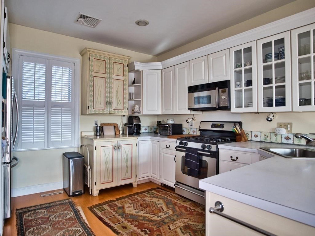 1958 Main Road Westport, MA 02791 - Photo 9 of 28 a kitchen with stainless steel appliances granite countertop a stove a sink and a microwave