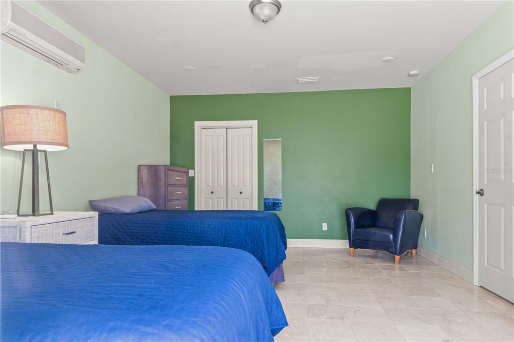 6515 Dimarco Road Tampa, FL 33634 - Photo 47 of 66 a bedroom with a bed and a chair