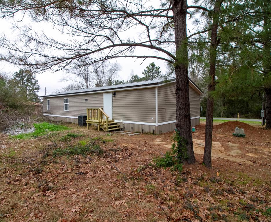 909 Old Arcadia Road Minden, LA 71055 - Photo 21 of 21 a backyard of a house with barbeque oven fire pit table and chairs
